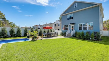 Enjoy a backyard with a swimming pool, barbecue area, and patio seating.