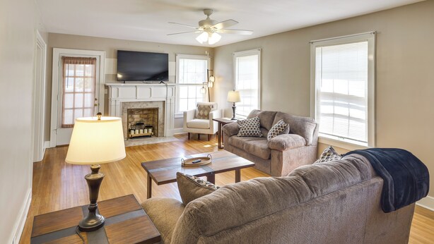 A living room with a fireplace, a television, a ceiling fan, and a sofa. - Charming Tullahoma Stay w/ Great Walkable Location (Tullahoma)