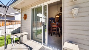 A patio with a table and chairs, a sliding glass door leading to an interior dining area, and a decorative wall piece. - 6 Mi to Dtwn Yakima: Central Washington Home (Yakima)