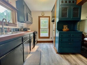 Frigorífico, microondas, utensilios de cocina y mesa de comedor