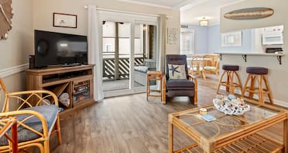 Serene condo with a pool view, screened balcony, washer/dryer, & central AC