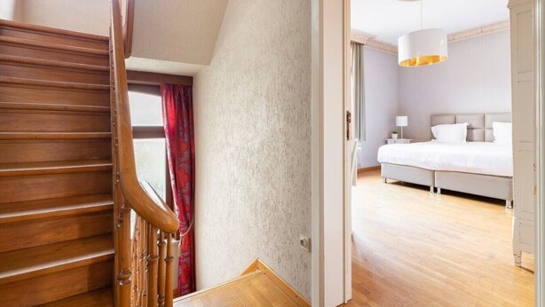 A bedroom with a bed, bedside tables, and a hanging light fixture. - ROOM N°1 / City Center Spacious King Suite * Private External Bathroom (Brugge)