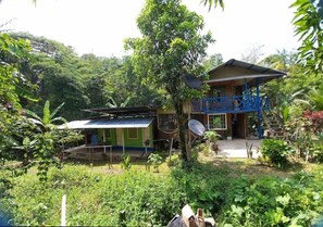 Enjoy the serene surroundings from the two-story house's spacious balcony, offering a satellite TV and stunning views.