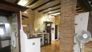 A compact kitchen with a washing machine, a microwave, and a sink.