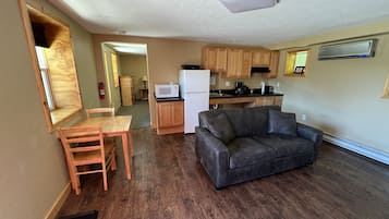 A compact living space with a kitchenette, a dining area, and a seating area.