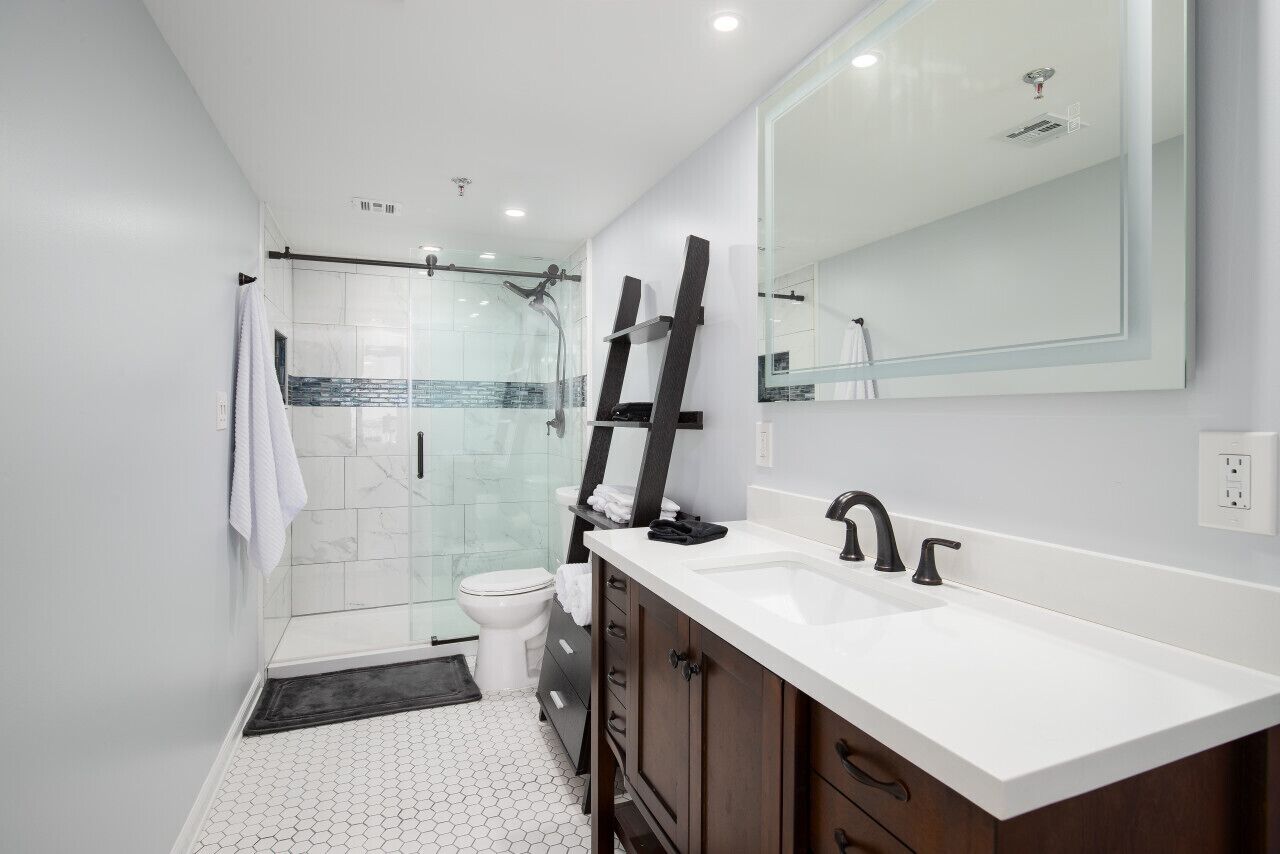 Totally renovated master bath with walk in shower and internally lighted mirror.