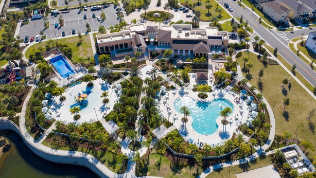 An aerial view of a resort with multiple swimming pools, landscaped areas, and residential buildings. - Wonderful 9BD 6BA Mariogamer Solararesort Sleep 22 (Kissimmee)