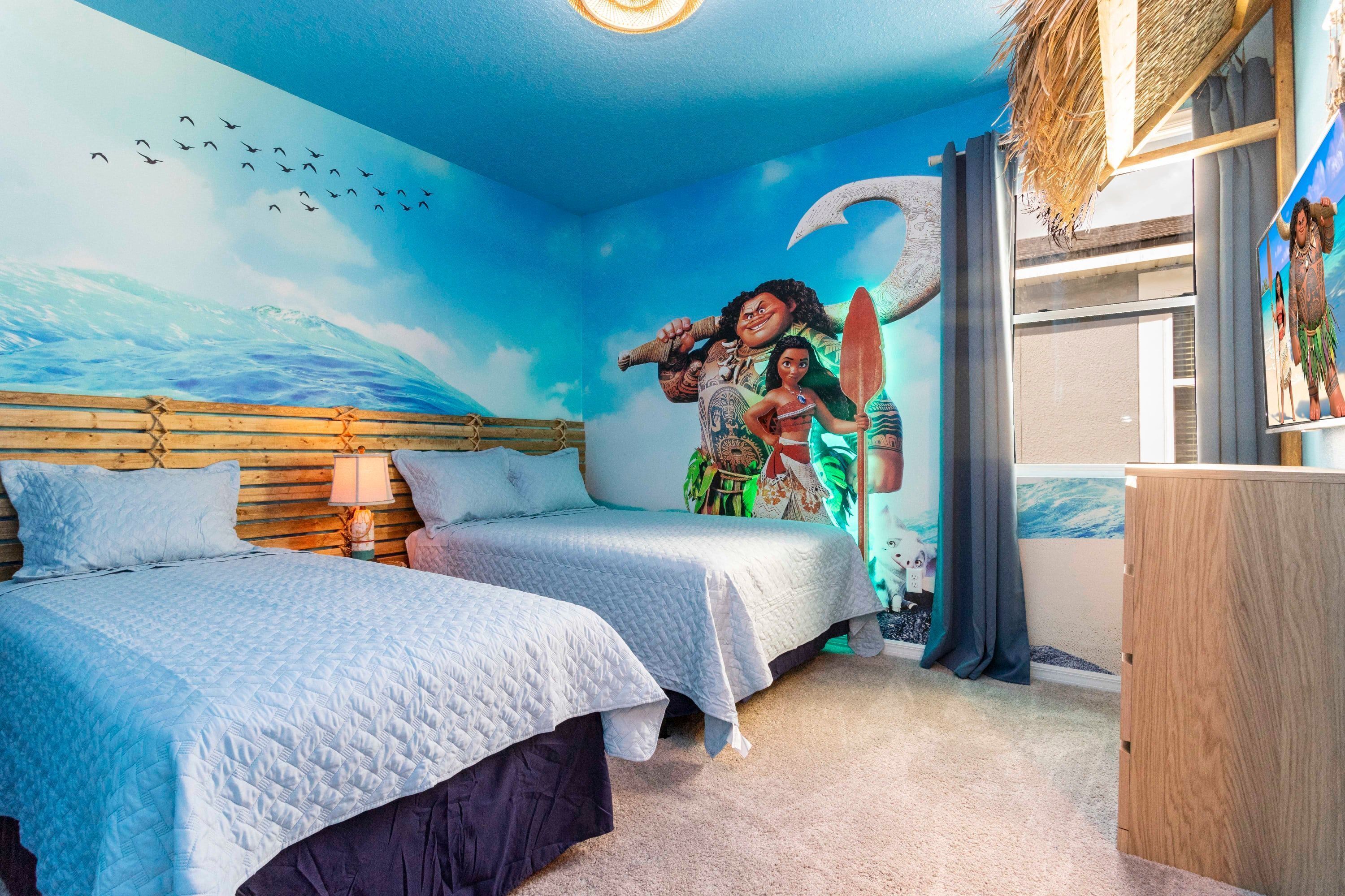 A bedroom with two beds, a mural of a beach scene, and a wooden headboard.