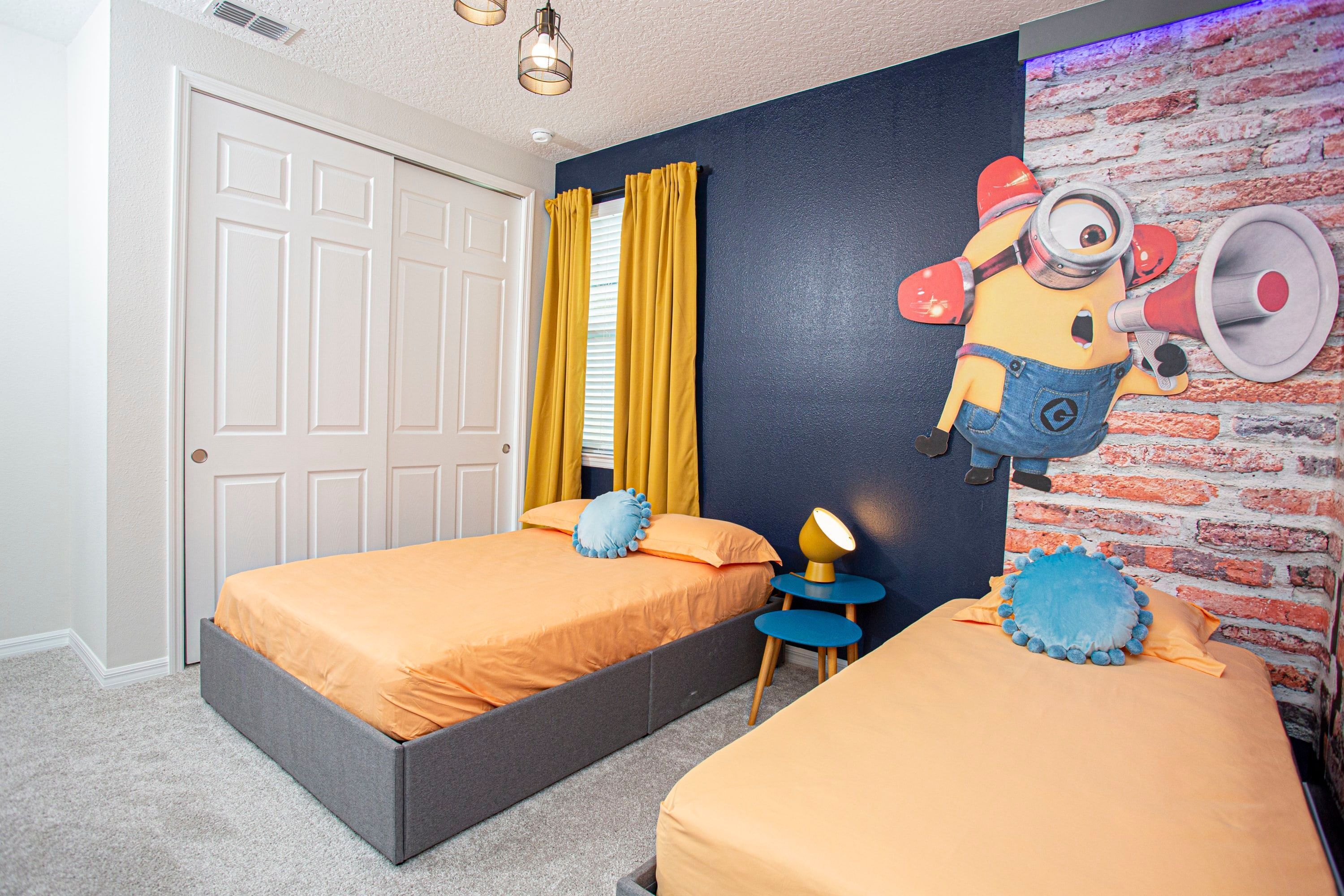 A bedroom with two beds, a brick wall mural, and a door.