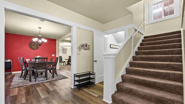 A staircase with a carpeted finish leading to a landing. - Spacious Home in the heart of the Bay (Oakland)
