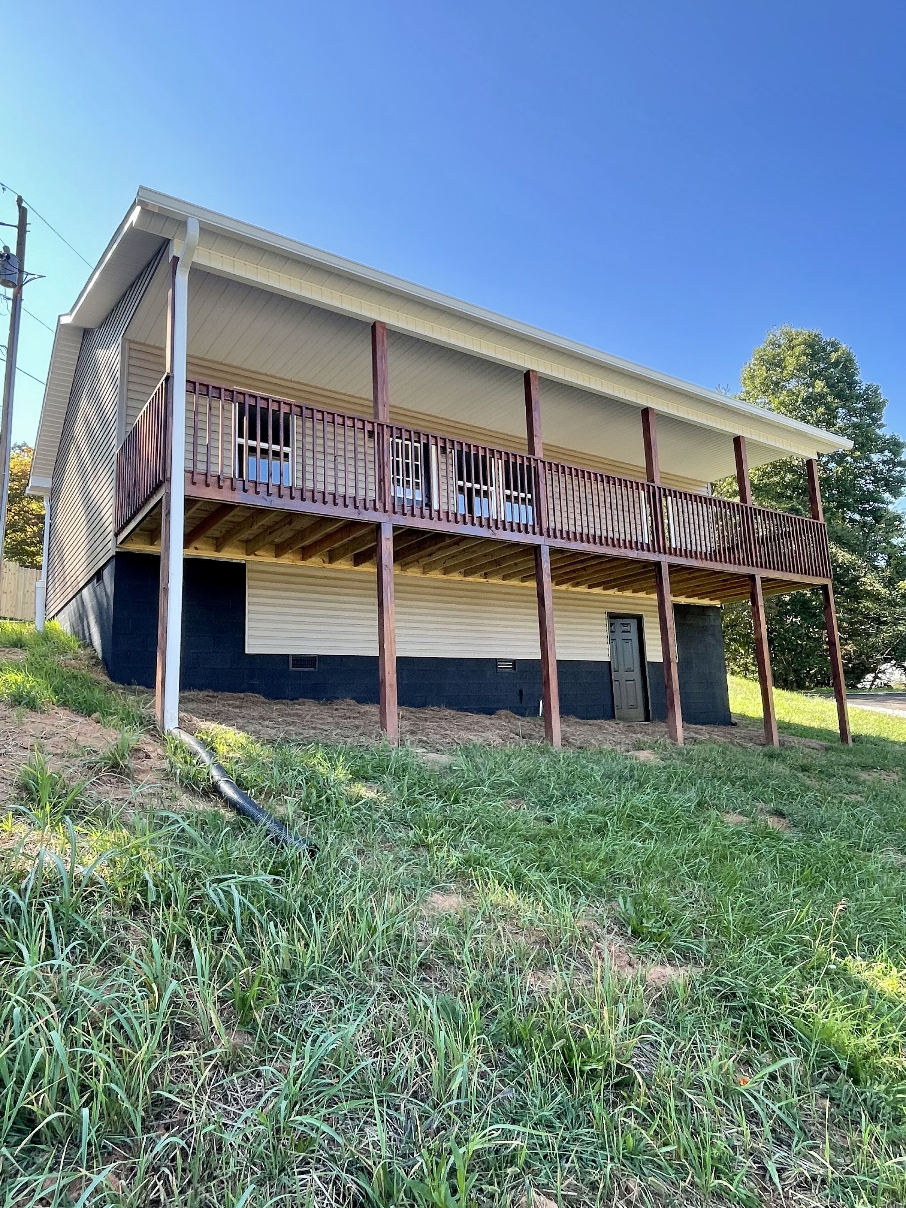 A two-story building with a covered porch and a small attached garage.
