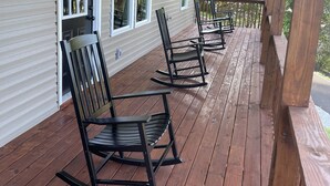 A covered porch with wooden flooring and black rocking chairs. - Cozy Sunset Retreat with a Beautiful Mountain View!  (Franklin)