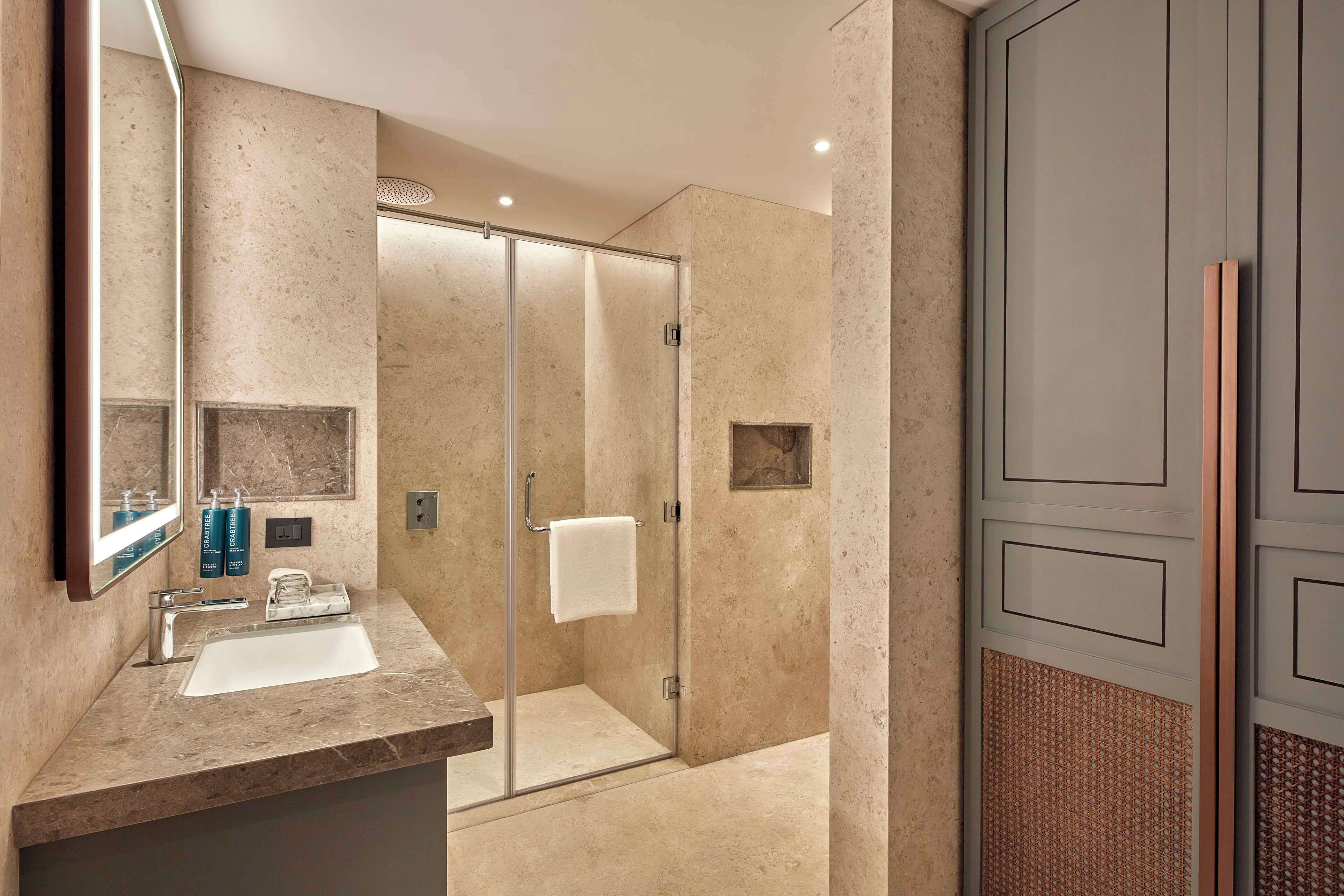 Suite, 1 King Bed (Ambassador) | Bathroom | Shower, rainfall showerhead, free toiletries, hair dryer