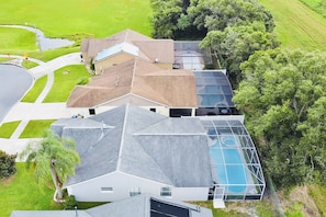 A residential property with a large swimming pool, multiple houses, and a well-maintained lawn. - Serene Family Getaway in Kissimmee w/ Pool, Hot Tub, MyAirbnbFlorida (Kissimmee)