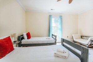 A hotel room with two single beds, a small table with a lamp, a chair, and a window with curtains. - Clonmel Acres: Hot Tub + Mins to Hazy Mtn & BMB (Afton)