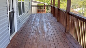 A wooden deck with a railing, a door, and windows. - Relaxing Hillside Getaway with a Mountain View (Franklin)