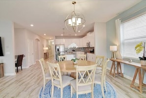 A dining area with a round table, chairs, and a chandelier. - Beautiful Home In Davenport, FL (Davenport)