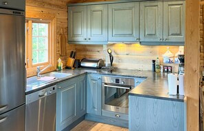 Fridge, dishwasher, coffee/tea maker, cookware/dishes/utensils