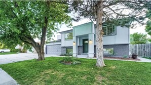 A modern two-story house with a well-maintained lawn, a driveway, and a garage. - Loveland Oasis w/ Indoor Heated Pool & Game Room (Loveland)