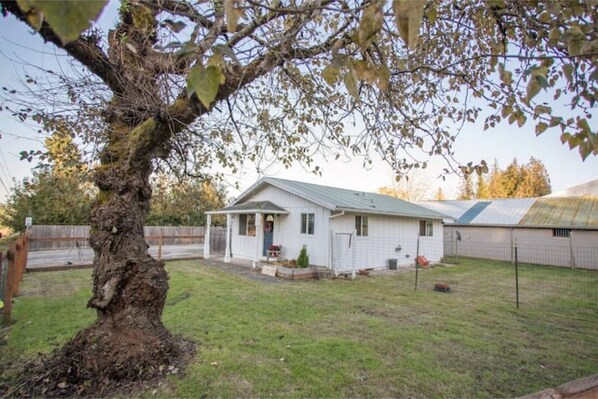 A single-story house with a sloped roof, a front porch, and a small front yard.