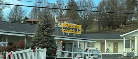 A hotel with a signboard reading "Dixie Plaza Hotel Office".