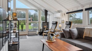 A cozy living room with a fireplace, a sofa, a coffee table, and a bookshelf. - Amazing home in Tarm with WiFi (Tarm)