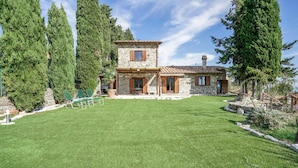 A stone house with a stone chimney, a stone fireplace, and a small deck with chairs. - Pet friendly home in Campiglia D'orcia (Campiglia D'orcia)