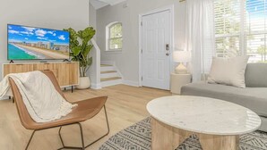 A living room with a TV, a sofa, a coffee table, and a chair. - 4-min Walk to Ocean|2 King Suites|Beach Retreat (Myrtle Beach)