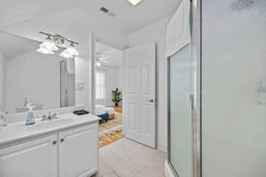 Bathtub, hair dryer, towels, shampoo