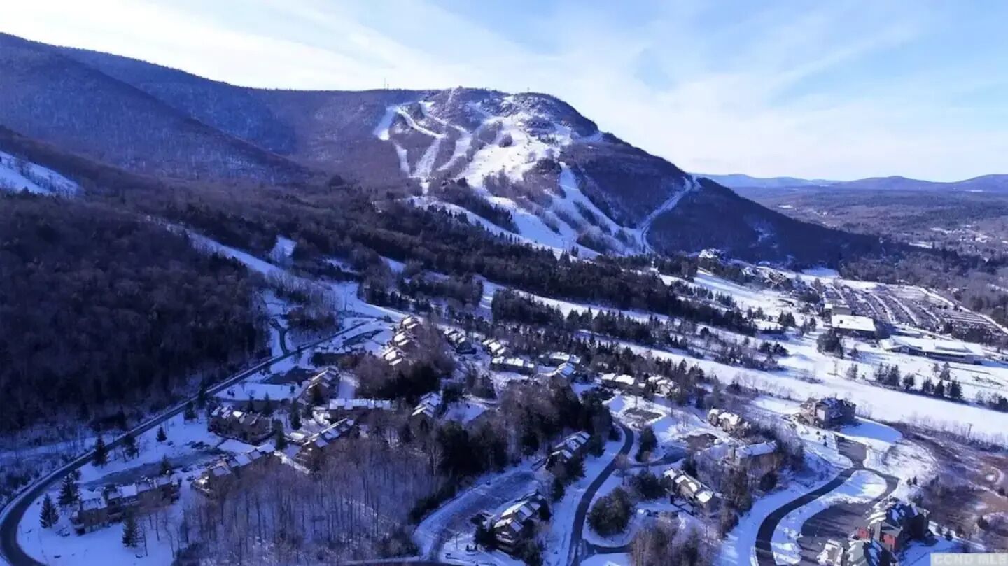 A snow-covered mountain landscape with a small town nestled at the base.