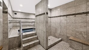 A modern bathroom with a marble floor, a built-in shower, and a glass-enclosed jacuzzi. - El Matador 114 - FREE TICKETS!! Your stay includes free tickets to many area attractions! (Fort Walton Beach)