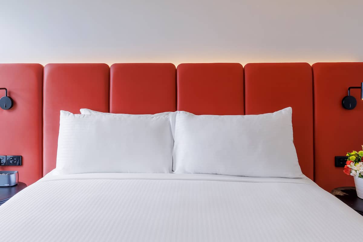 Desk, iron/ironing board, bed sheets