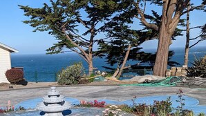 A garden with a fountain, a pool, and a view of the ocean. - Sparkling Clean, Private & Quiet! Amazing Ocean Views [1] (Brookings)