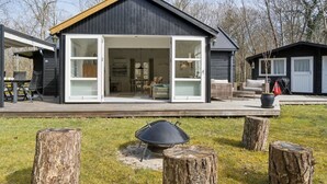 A modern house with a large open garage, a deck, and a barbecue area. - "Lucie" - 50m from the sea by Interhome (Rønne)