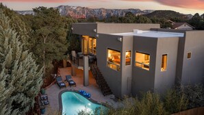 A modern house with a pool, outdoor seating, and a view of mountains. - Two Custom Homes with Pool, Spa, Rooftop Deck (Sedona)