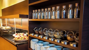 A buffet area with various food items and condiments. - Best Western Conference Airporthotel Frankfurt Mörfelden (Moerfelden-Walldorf)