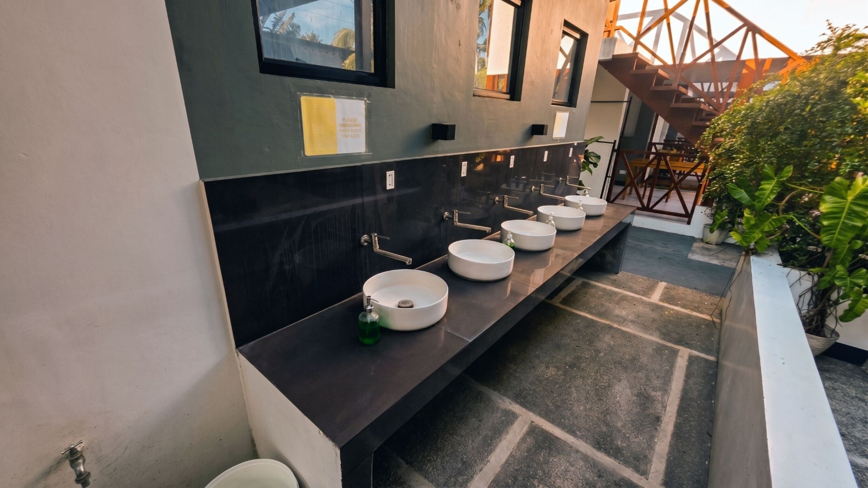 A modern bathroom with multiple sinks and a large mirror.