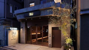 A building with a sign that reads 'EU' and a smaller sign below it that says 'Namba Minami by Doyanmen.'