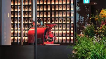 A modern building facade with a coffee machine and a wall of coffee bags.