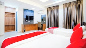 A hotel room with a bed, a desk, a TV, and a wardrobe. - Hope Hotel (Masai)