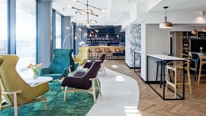 A modern bar area with seating and a wine display. - B&B HOTEL Tomaszów Lubelski (Tomaszow Lubelski)