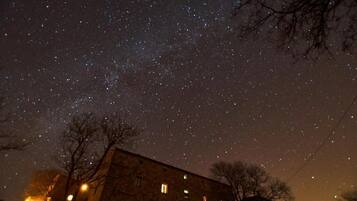 A building with multiple windows against a starry night sky.