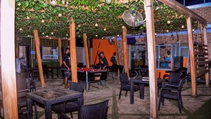 An outdoor bar area with tables and chairs, a pool table, and a fan. - Rivera Hotel and Suites (Ijede)