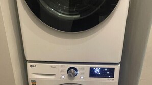 A stacked washer and dryer unit with a digital display. - Spacious 3-Bed Brownstone, near Columbia Uni (New York)