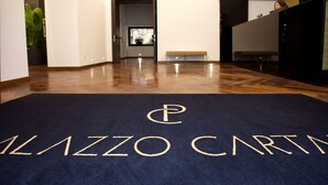 A hotel lobby with a dark blue carpet featuring the name "PALAZZO CARTA". - PALAZZO CARTARI (Palermo)