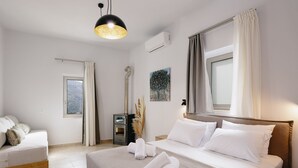 A modern hotel room with a bed, bedside table, and a window with curtains. - Kedros Villa, A Luxury Touch (Rethymno)
