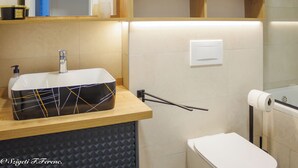 A modern bathroom with a rectangular sink, a toilet, and a towel rack. - Apartment Sleeps 4 With Sea View (Rijeka)
