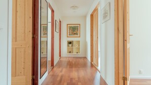 A hallway with wooden doors and a framed picture on the wall. - Marina View |3 Bedroom Apartment |Central Tórshavn (Tórshavn)