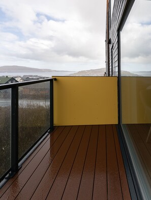 Enjoy the serene coastal views from this deck with a glass balustrade.