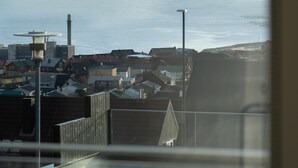 A coastal cityscape with buildings and a view of the sea. - Stylish Studio Apartments (Tórshavn)